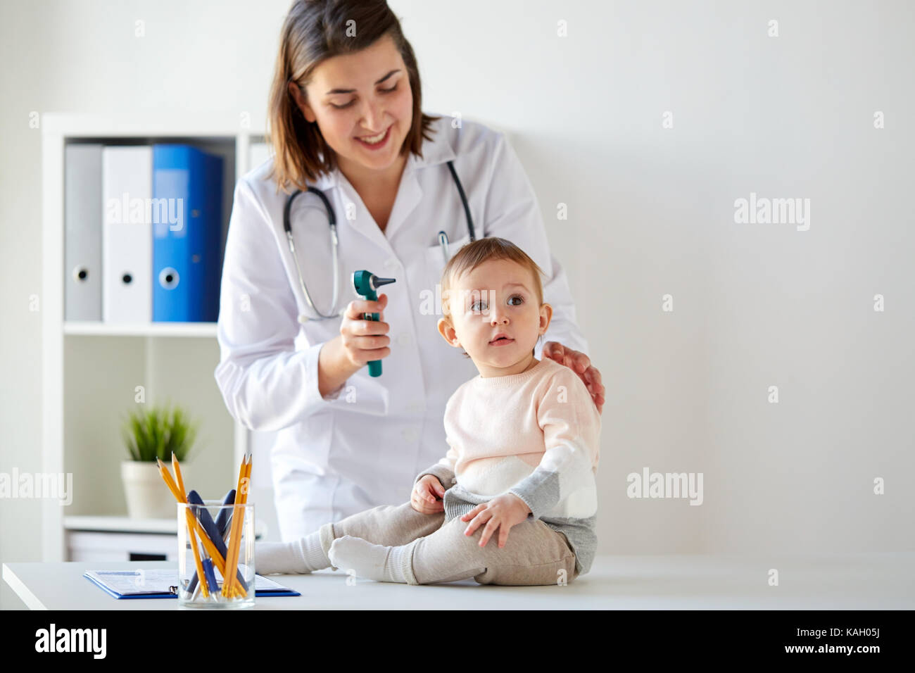 doctor with baby and otoscope at clinic Stock Photo Alamy