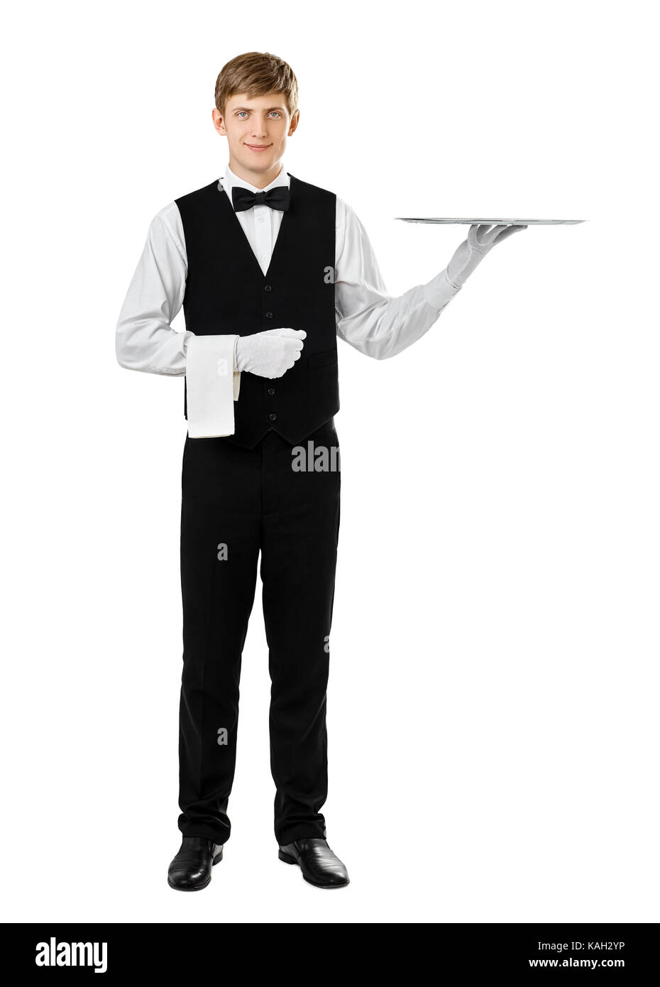 Full length portrait of handsome elegant waiter holding empty silver tray isolated on white background Stock Photo