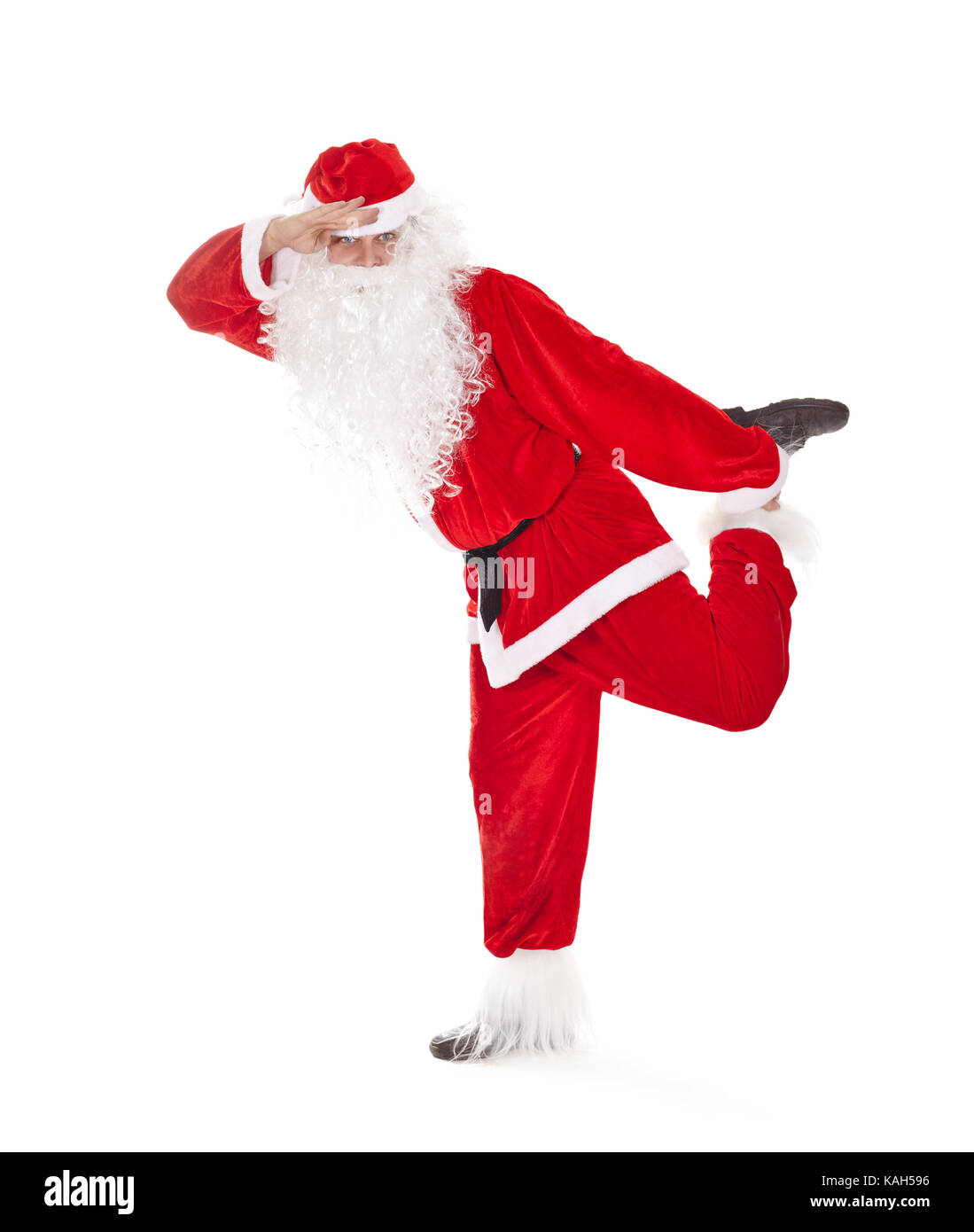 Happy Christmas Santa Claus having fun, standing on one leg and