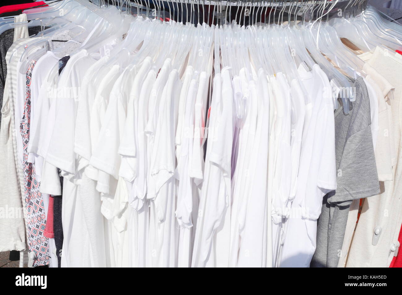 White T-shirts on a clothes rail Stock Photo