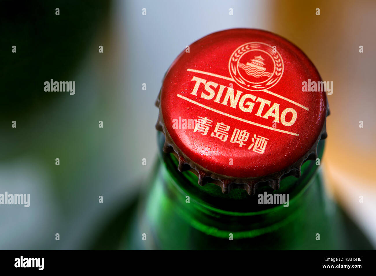 Beer bottle and cap - Tsingtao Japanese lager Stock Photo
