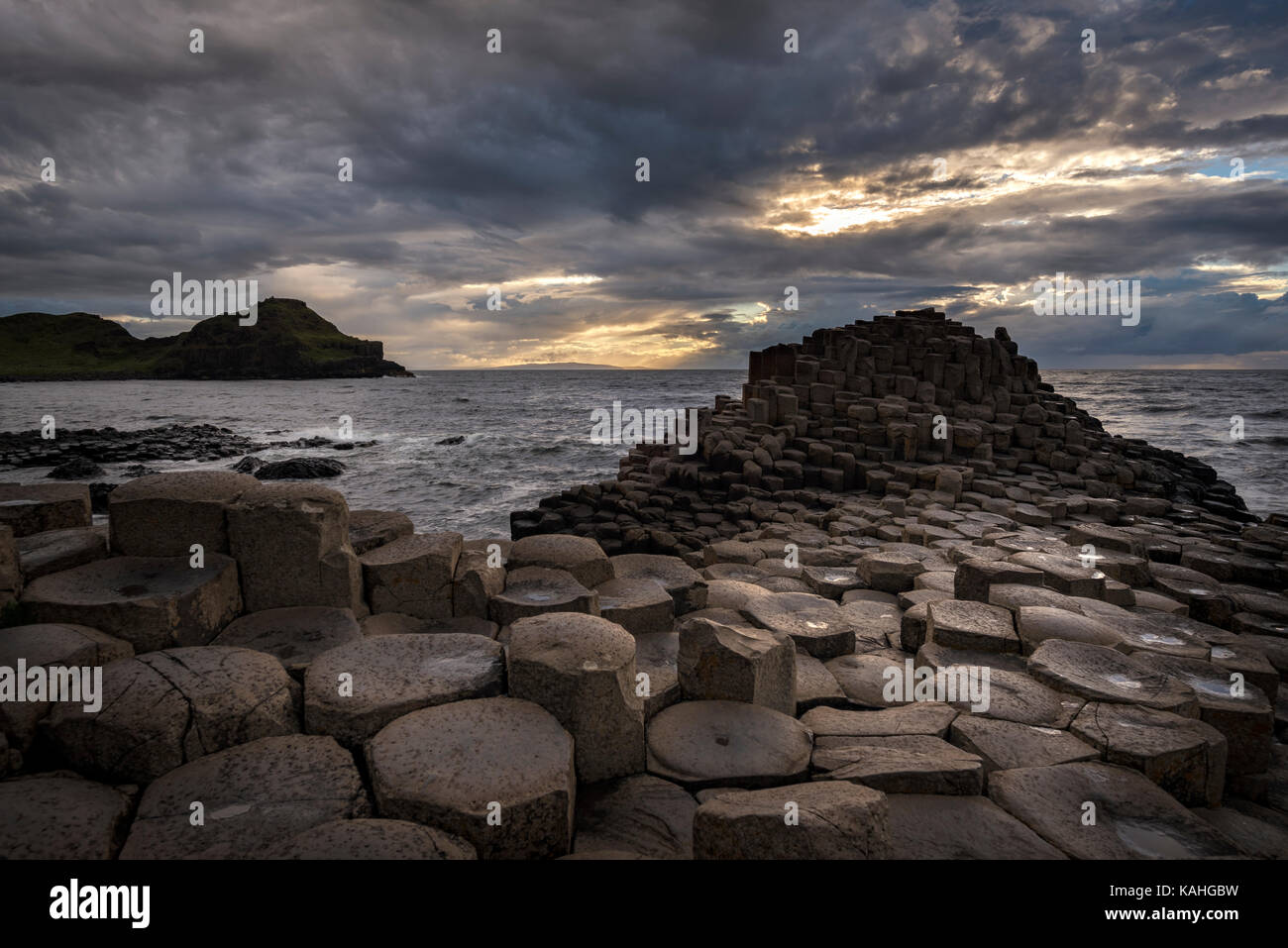 Basalt columns by the coast at sunset, Giant's Causeway, County Antrim, Northern Ireland, United Kingdom Stock Photo