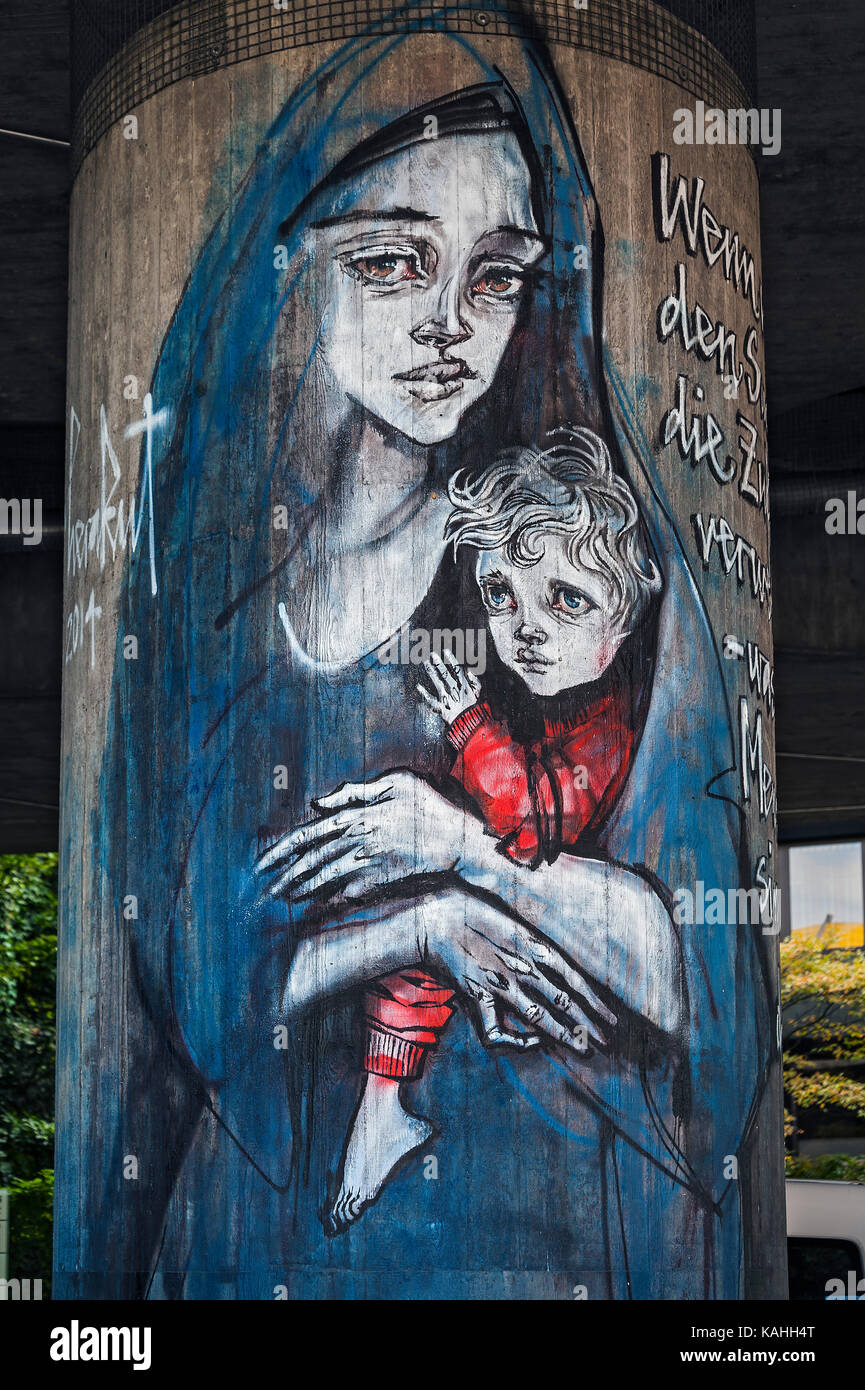 Graffiti on concrete pillars, refugee mother with child, Canditplatz, Munich, Bavaria, Germany Stock Photo