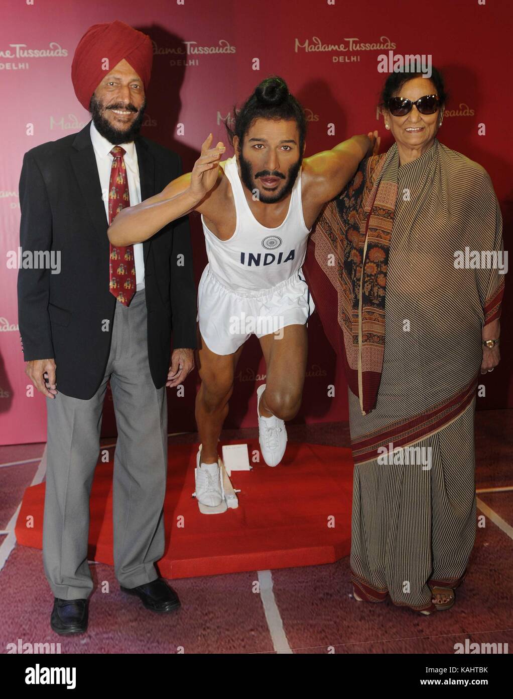CHANDIGARH, INDIA - SEPTEMBER 26: Legendary athlete Milkha Singh with wife Nirmal Kaur unveiling his wax statue for Madame Tussauds museum on September 26, 2017 in Chandigarh, India. Milkha Singh was the country's first athlete to win gold in the Commonwealth Games (1958 Cardiff) and missed a medal at 1960 Rome Olympic medal by a whisker, finishing fourth in the 400m final. The wax statue of Milkha Singh will share space with Mahatma Gandhi, Prime Minister Narendra Modi, Kapil Dev and Amitabh Bachchan and international celebrities such as Michael Jackson at the Madame Tussauds Delhi museum whi Stock Photo