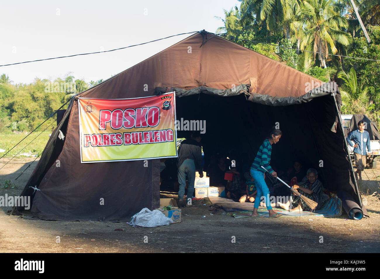 Bali, Indonesia. 26th Sep, 2017. A woman sweeps the floor of her tent at a temporary shelter for people who were evacuated from their villages located on the slopes of Mount Agung. Due to its increased volcanic activity, Mount Agung and the surrounding areas are on high alert. Credit: SOPA Images Limited/Alamy Live News Stock Photo