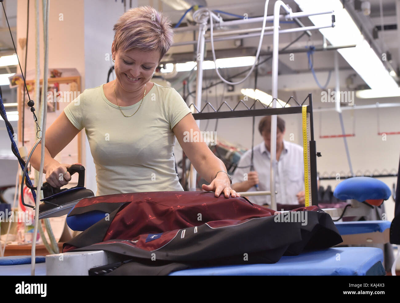 Trest, Czech Republic. 25th Sep, 2017. Trest clothing cooperative Vyvoj belongs to the largest clothing companies in Czech Republic, which kept their own production. Besides men's suits, the company sewing professional clothing for extreme conditions. On the photo is seen an ironing of suits, in the production plant in Trest, Czech Republic, on September 25, 2017. Credit: Lubos Pavlicek/CTK Photo/Alamy Live News Stock Photo