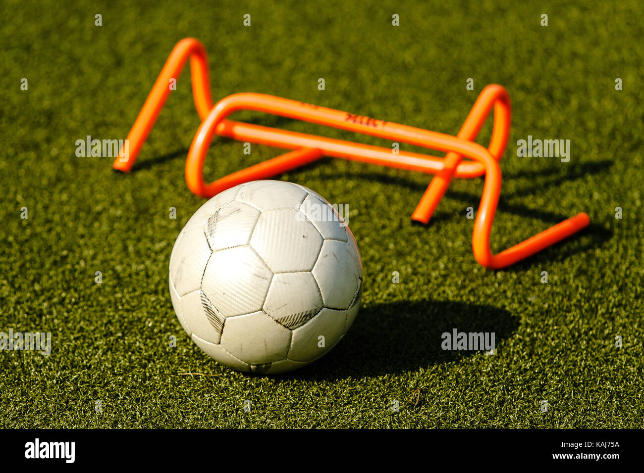 Soccer practice gear lies on the grass Stock Photo