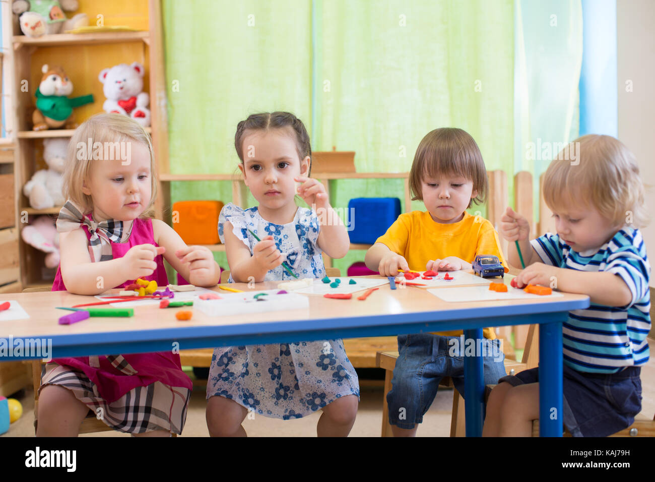 Kids group making arts and crafts in kindergarten or daycare center Stock Photo