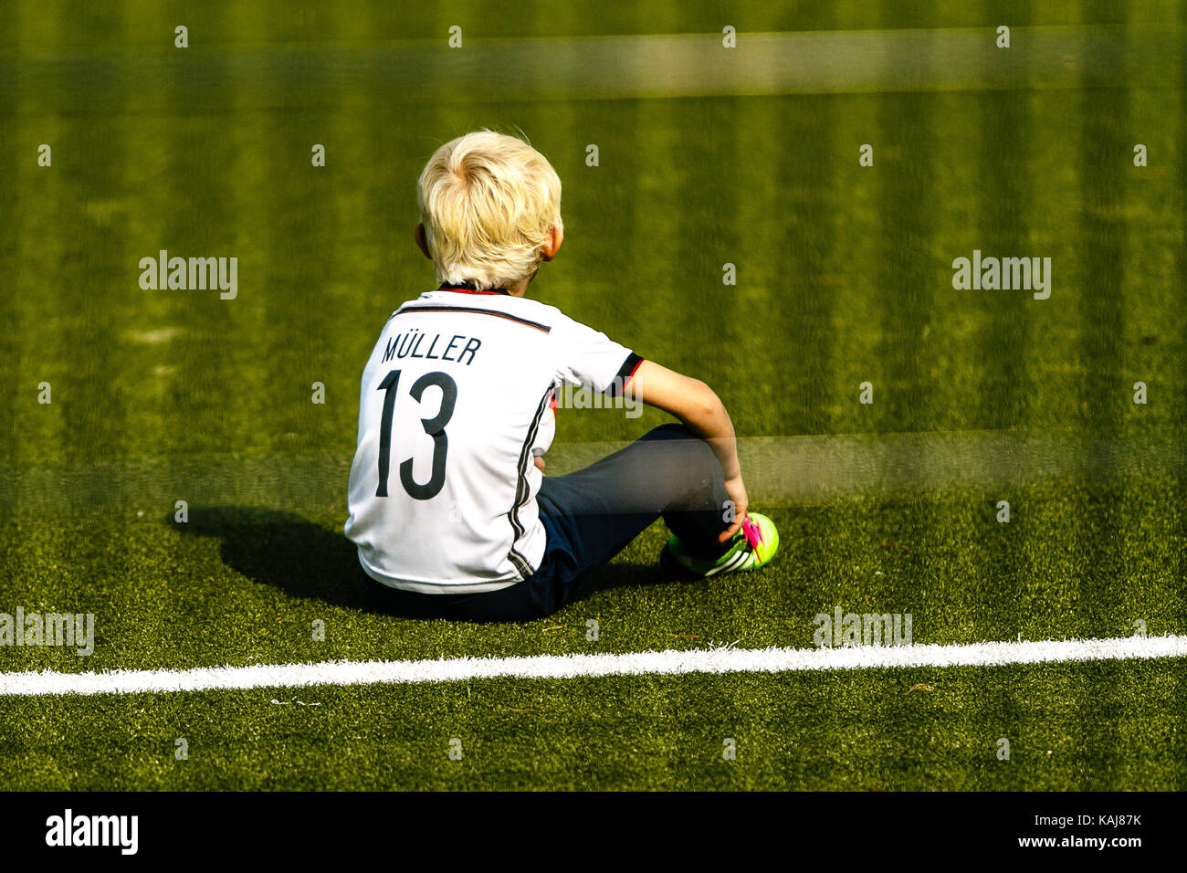 Young boy wears the national soccer jersey of Germany from player Thomas Mueller Stock Photo