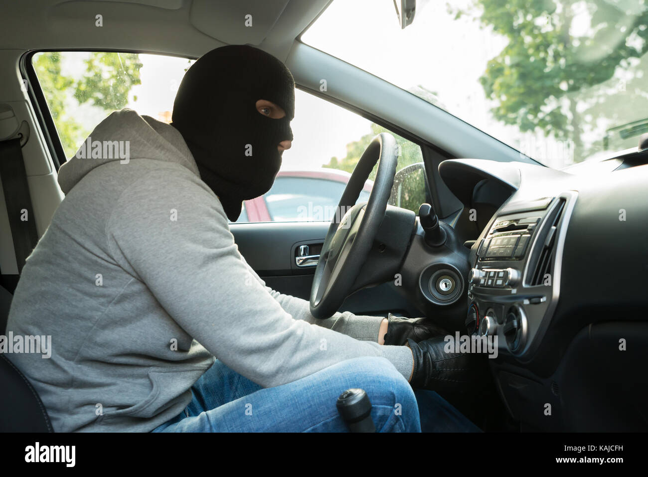 Thief With Mask Trying To Steal A Car Stock Photo