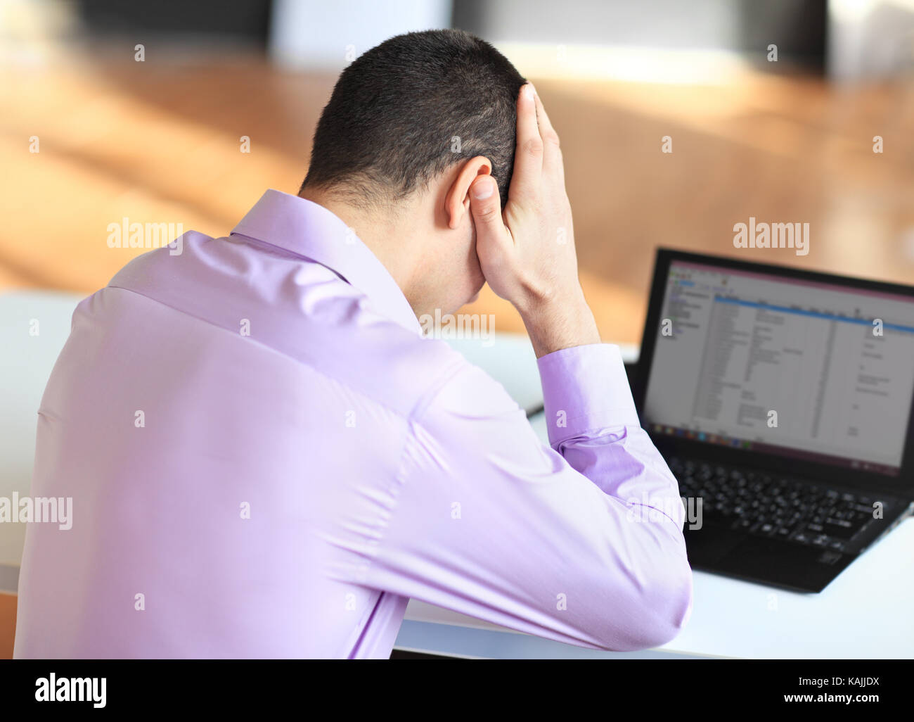 Portrait of stressful tired young businessman at work Stock Photo