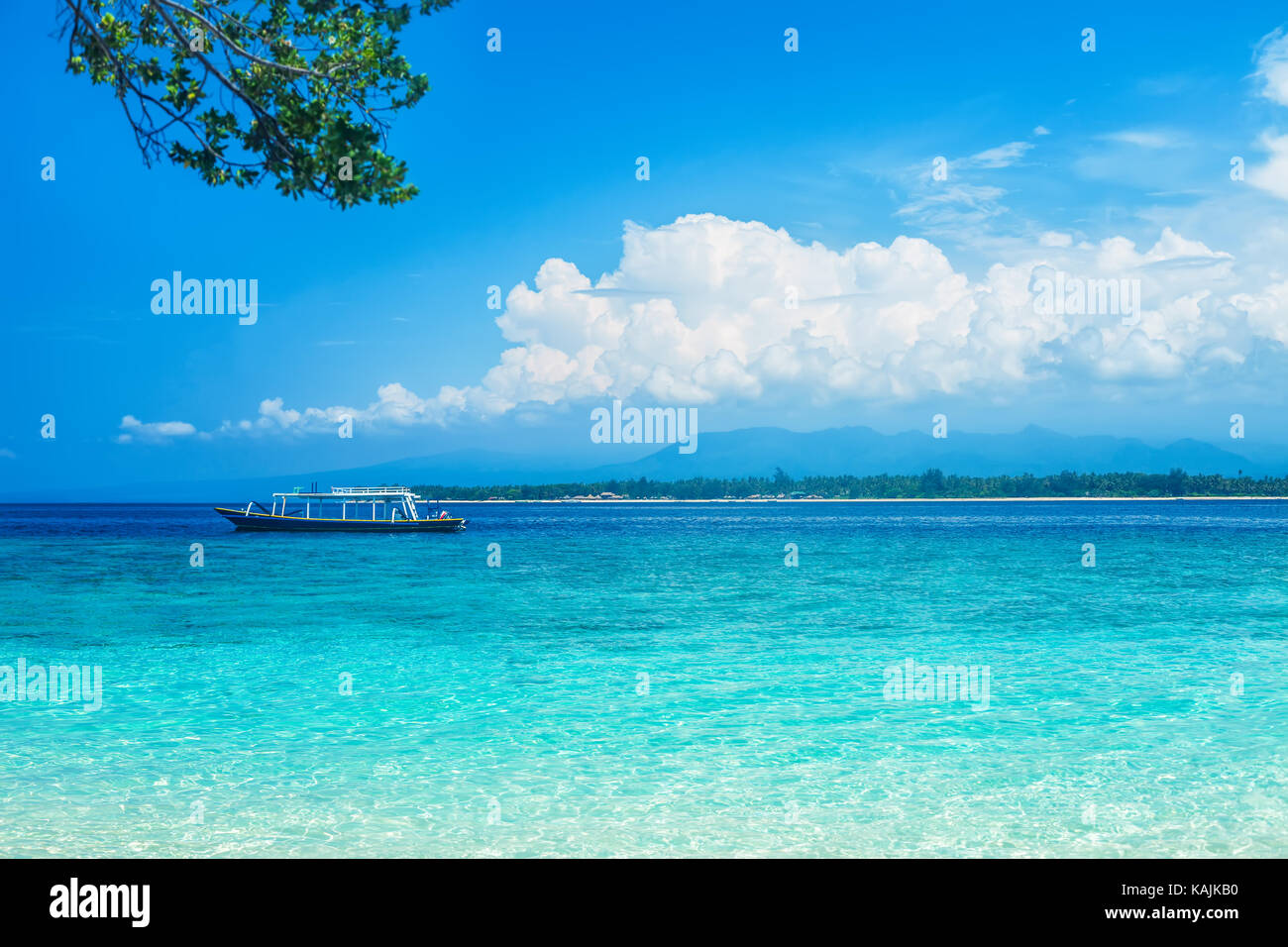 Beautiful tropical turquoise sea with boat on horizon. Vacation Stock Photo