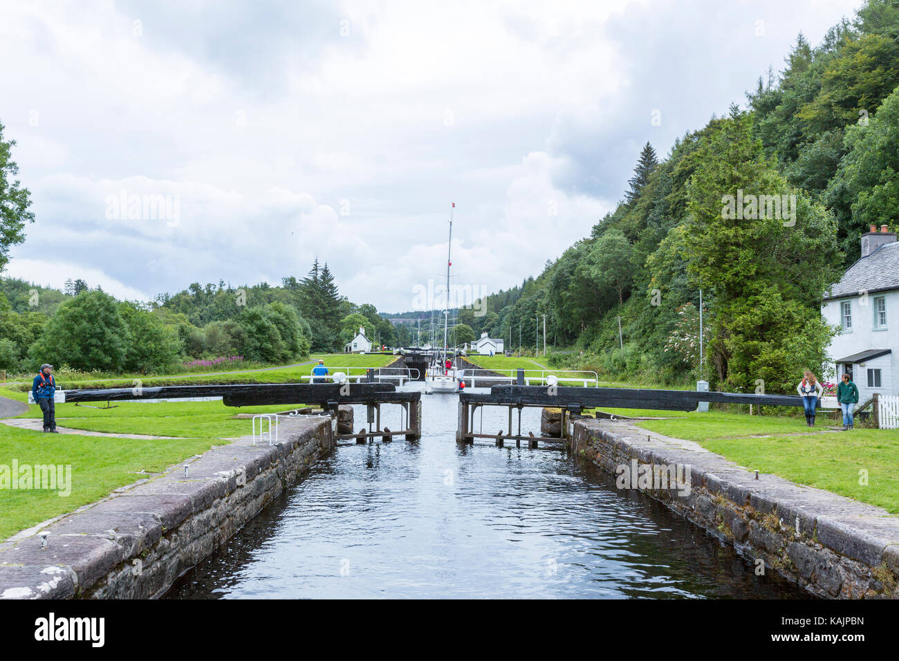 Opening the locks to allow a boat crossing a lock in Dunardry locks, Crinan Canal, Argyll and Bute Scotland Stock Photo
