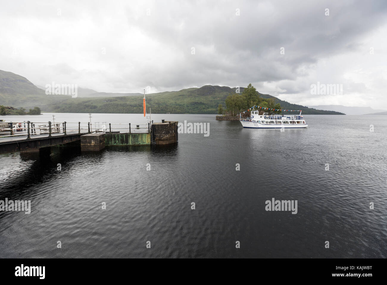 Tourist boat leaving Stronachlachar, Loch Katrine, Trossachs, Scottish Highlands, Scotland Stock Photo