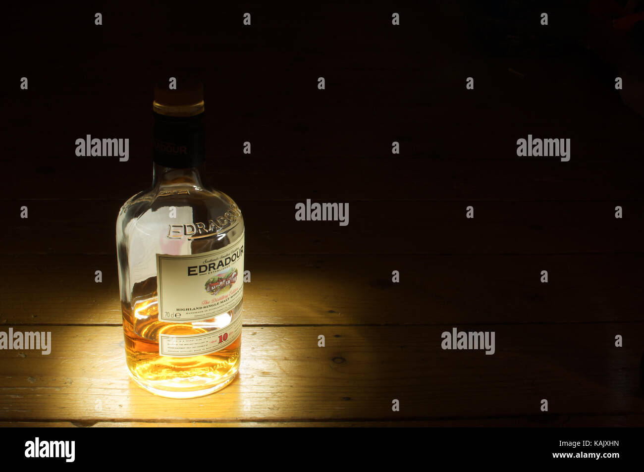 Bottle of Edradour whisky highlighted against a black background Stock Photo