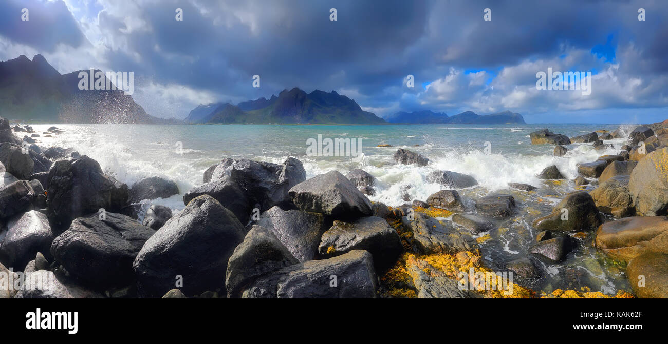 Sunny day at norway coastline. Beautiful north landscape with huge stones of norwegian sea. Panoramic view of Lofoten northern beach. Stock Photo