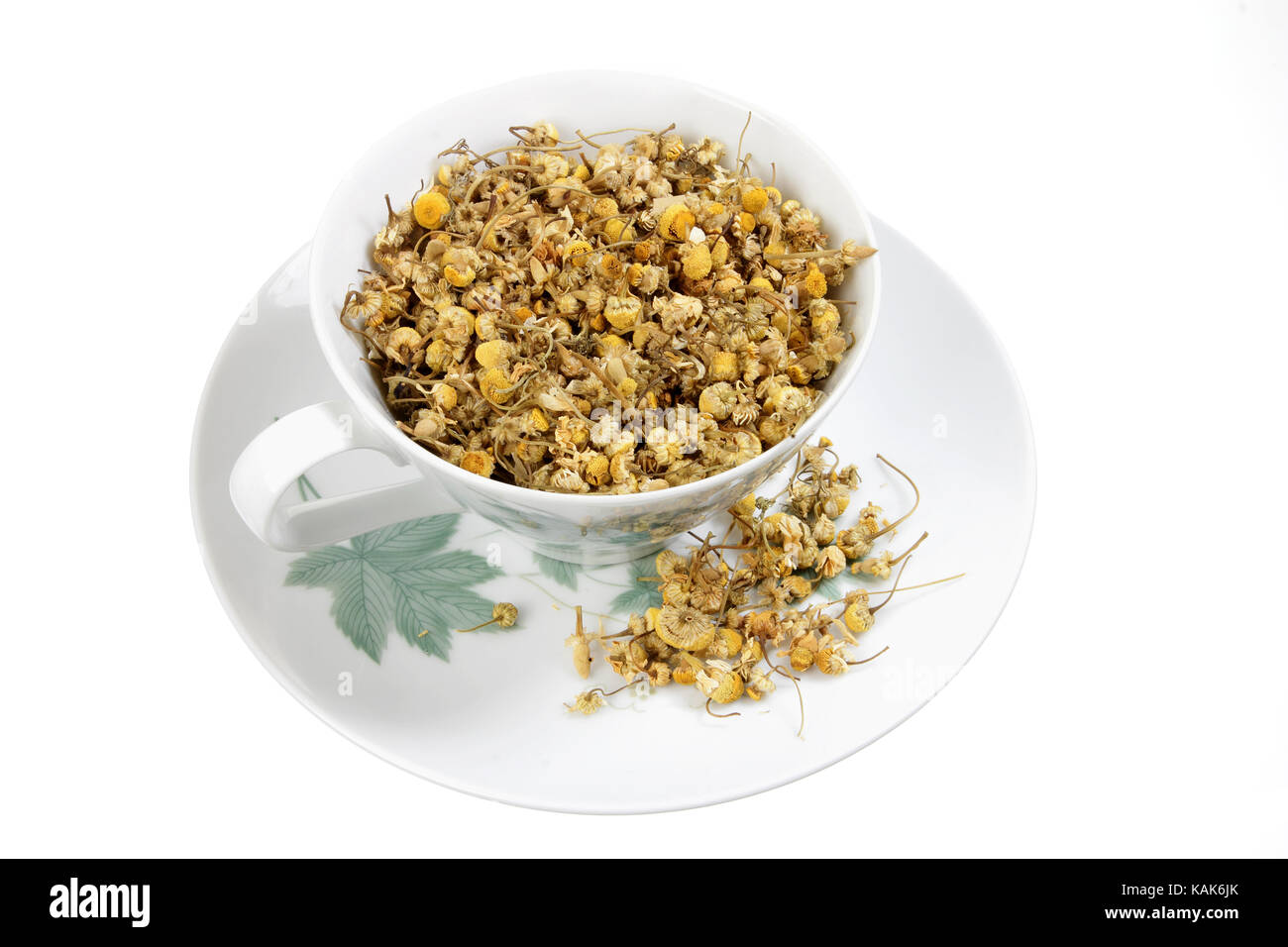 Dried Chamomile Tea in Cup on White Background Stock Photo