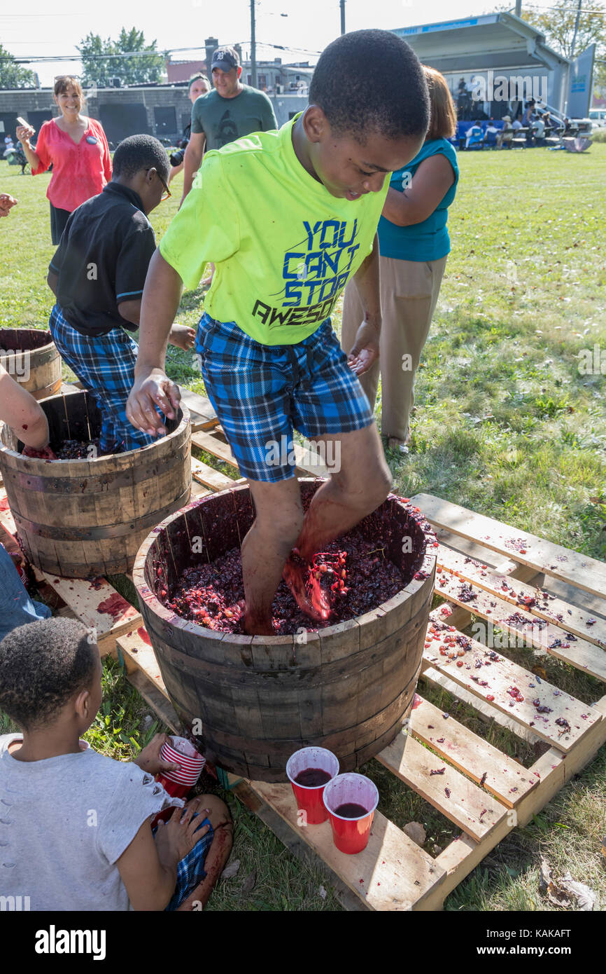 Detroit, Michigan - Children participate in a grape stomping contest at a block party in the Morningside neighborhood. Stock Photo