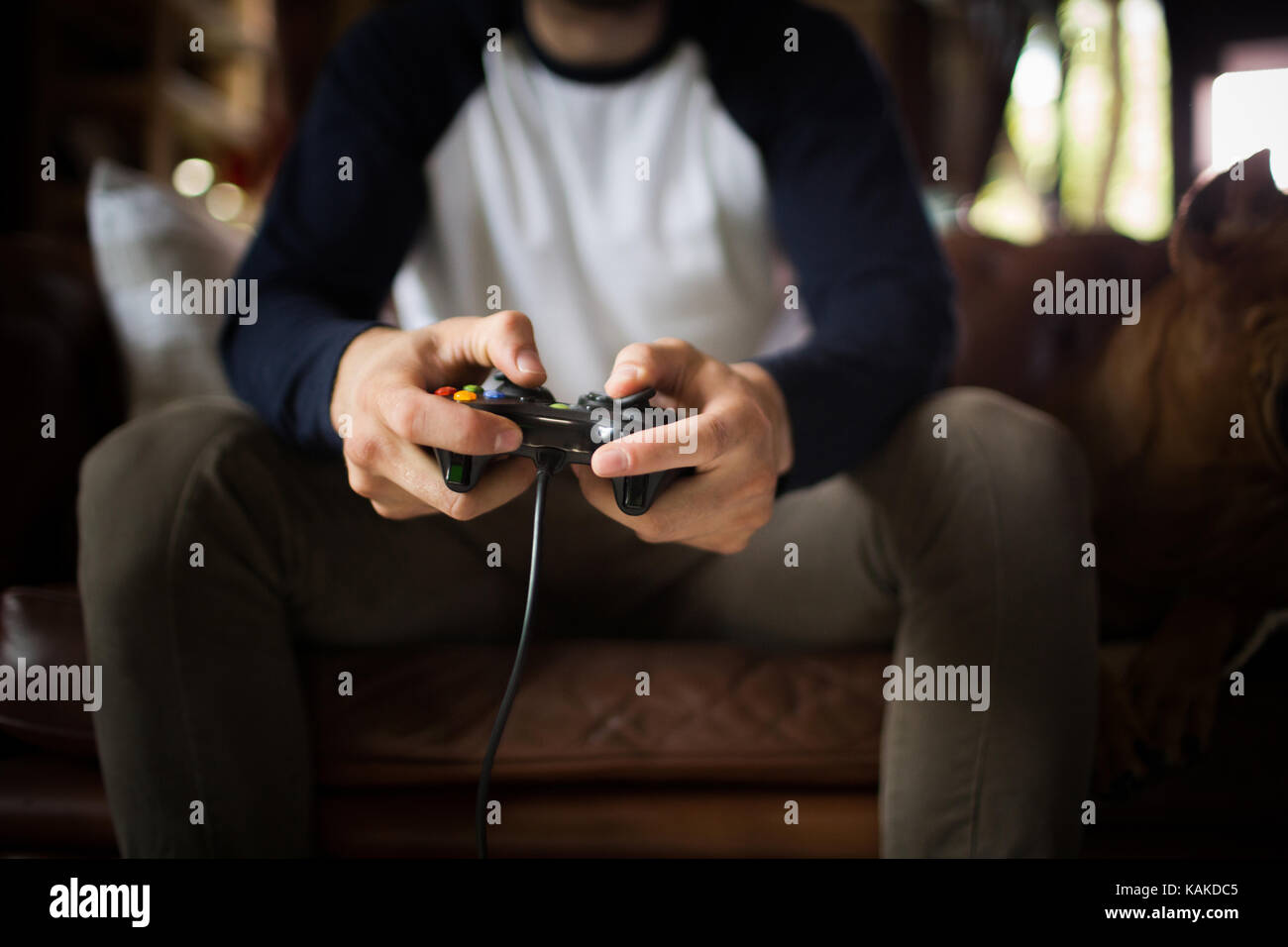 A young man holding joystick, playing video game. Stock Photo
