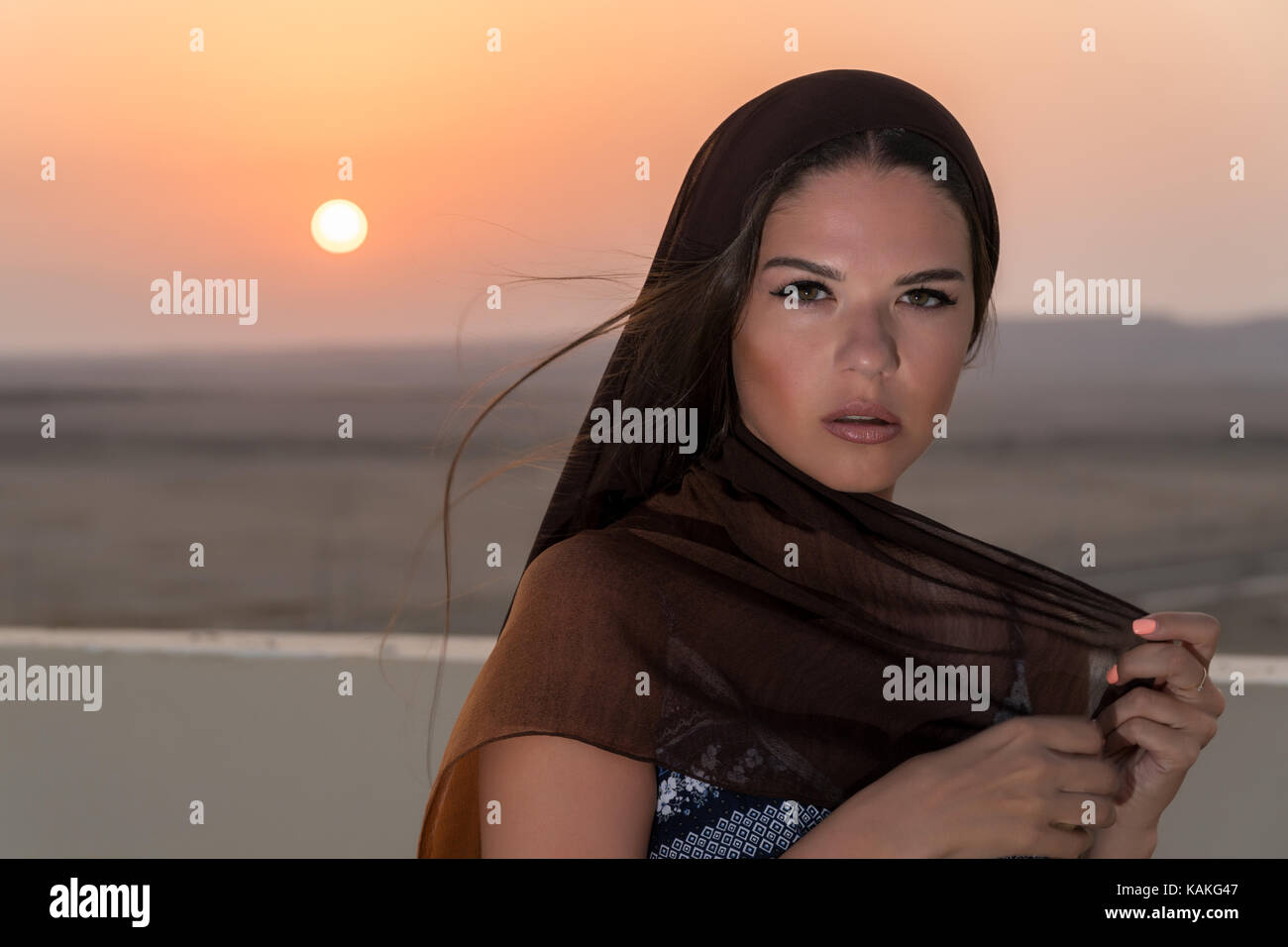 A beautiful girl dressed in Arabic style, standing on the roof at ...