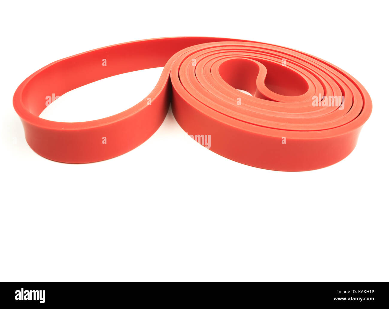 Red exercise resistance band on a white background with writing space Stock Photo