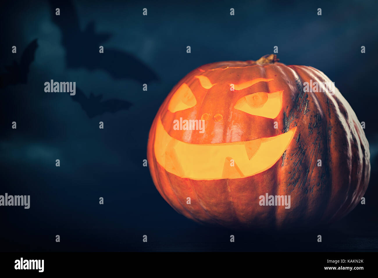 Three halloween Jack O' Lantern pumpkins on dark night background Stock ...