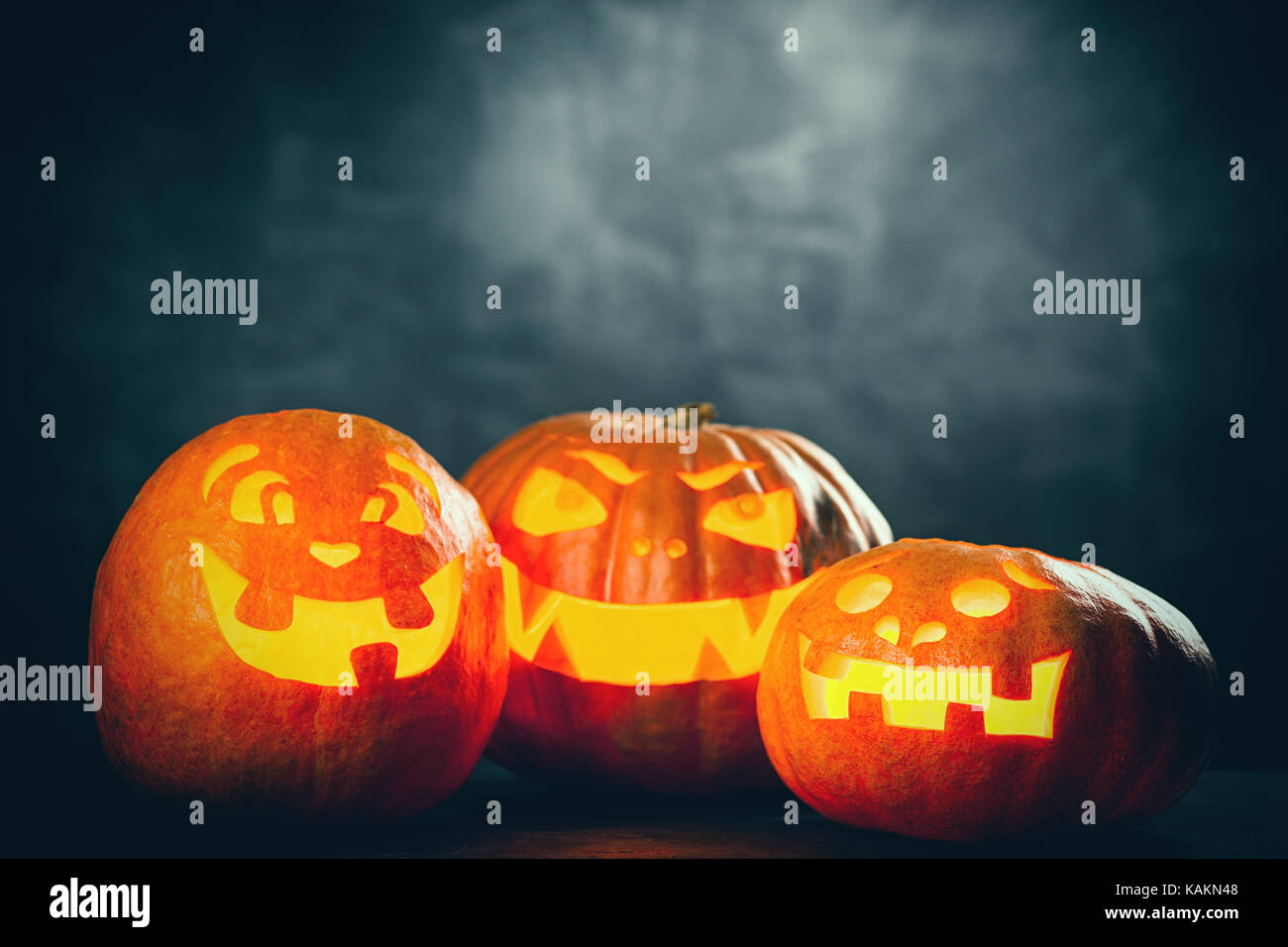 Three halloween Jack O' Lantern pumpkins on dark night background Stock ...