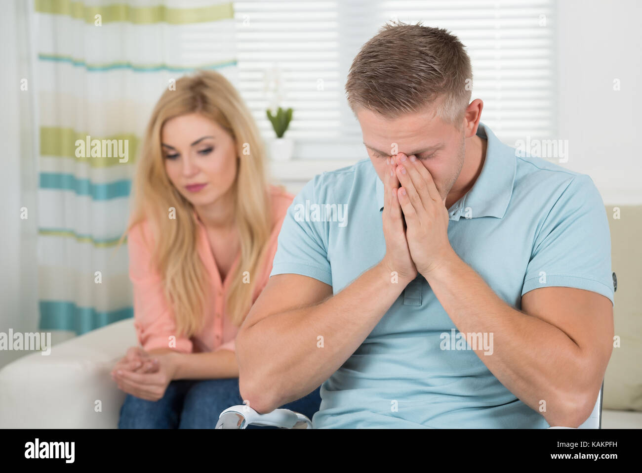 Unhappy young couple having argument at home Stock Photo