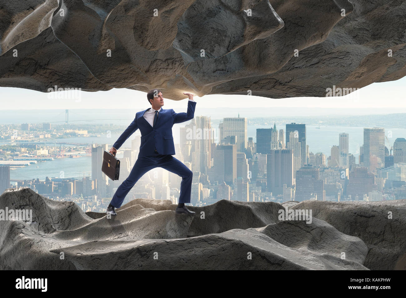 Businessman supporting stone under pressure Stock Photo - Alamy