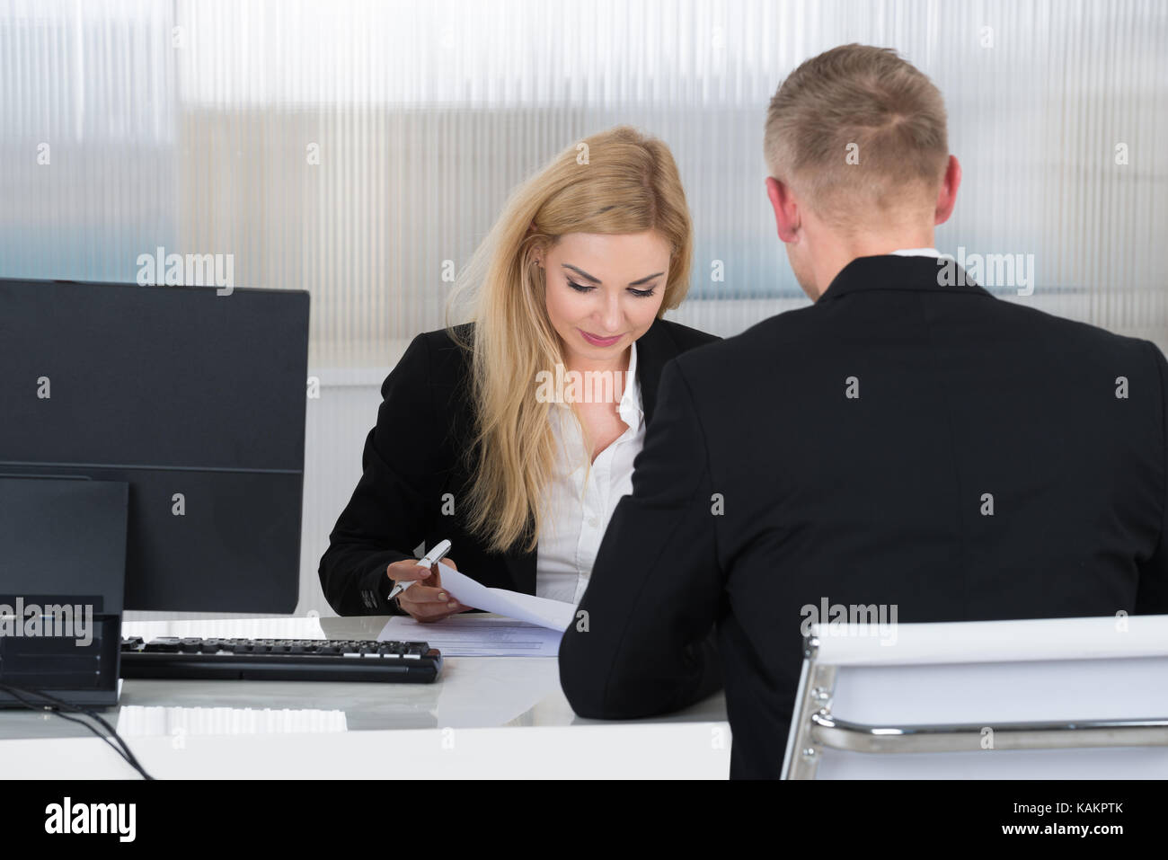 Young businesswoman interviewing job applicant at desk in office Stock Photo
