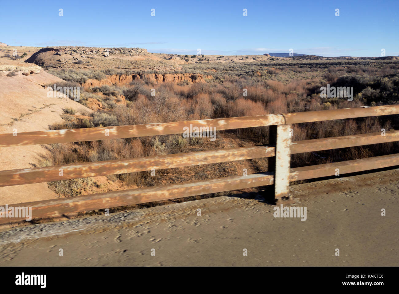 A rocky canyon filled with brush from an old bridge guard rail Stock Photo