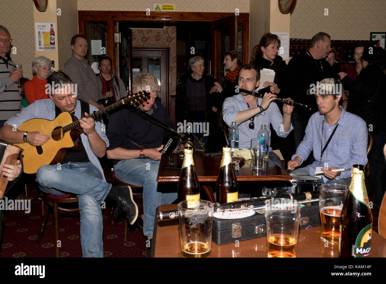 Men playing traditional music inside an Orkney pub Stock Photo