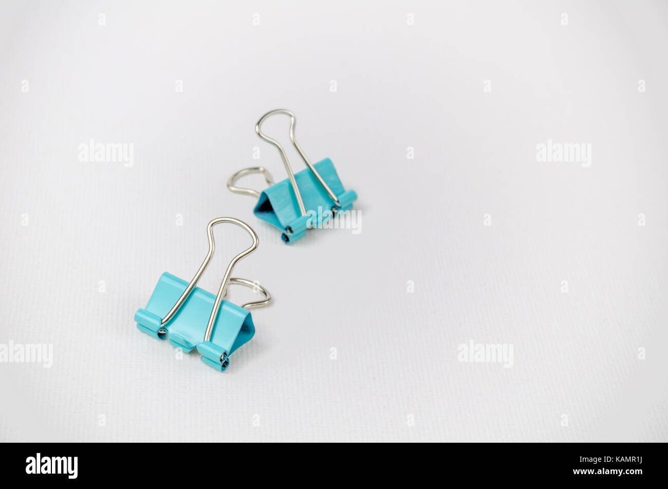 A Studio Photograph of a Pair of Turquoise Bulldog Clips Stock Photo