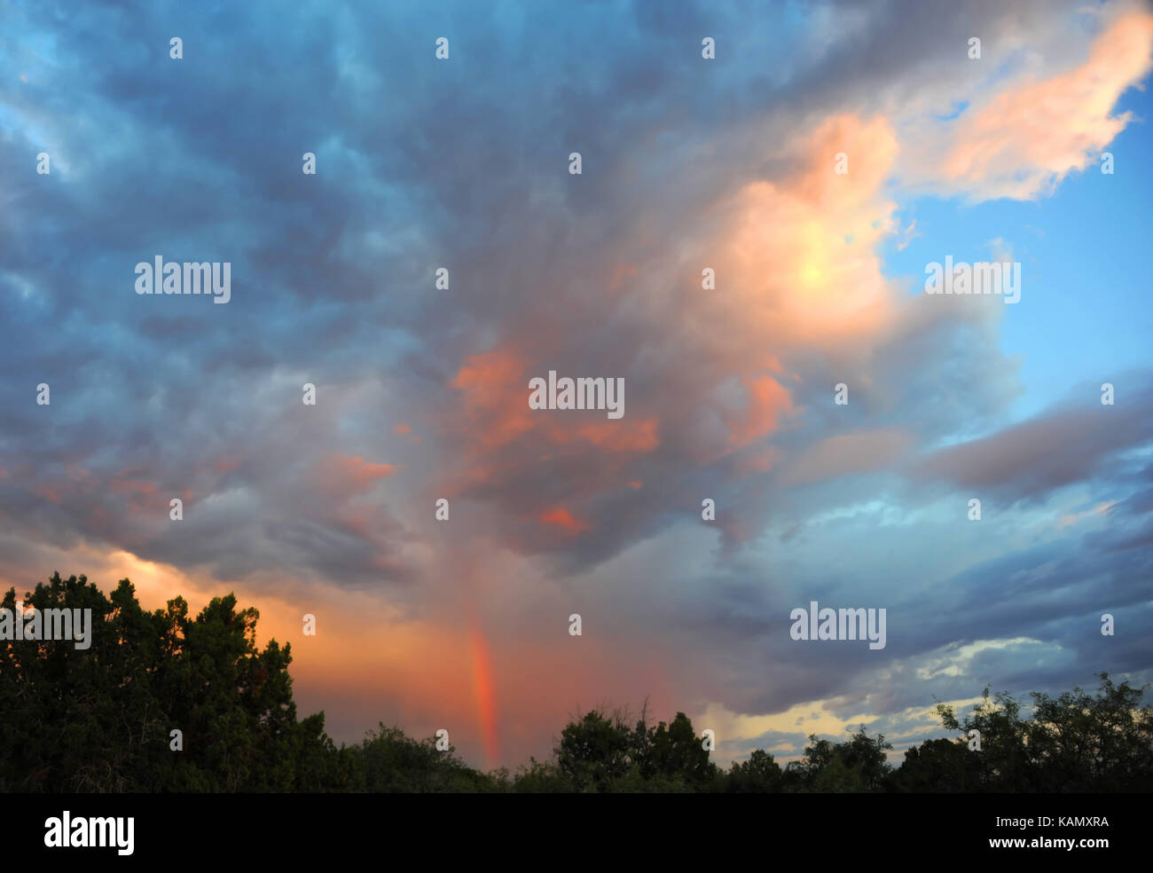 Rainbow appears in the sunset sky over Phoenix, Arizona. Blue merges