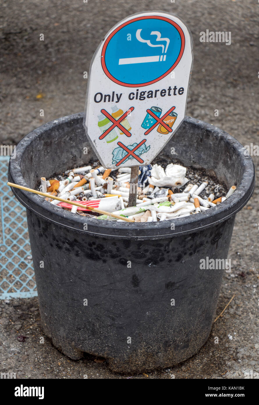 Public ashtray on the street. Container for cigarette butts. Plastic pot  for cigarettes only Stock Photo