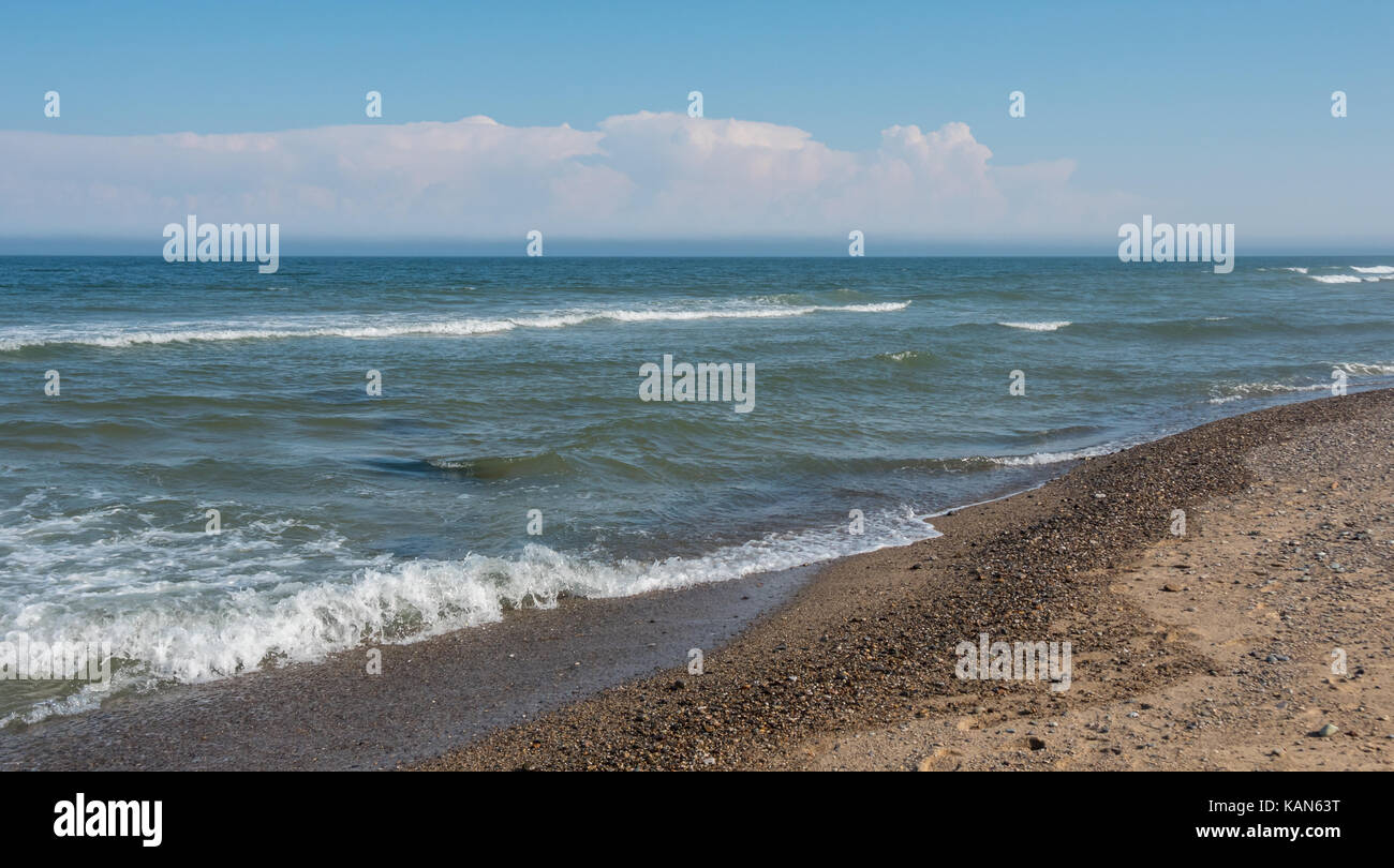 Clear Ocean Water on Rocky Beach with mostly clear skies Stock Photo ...