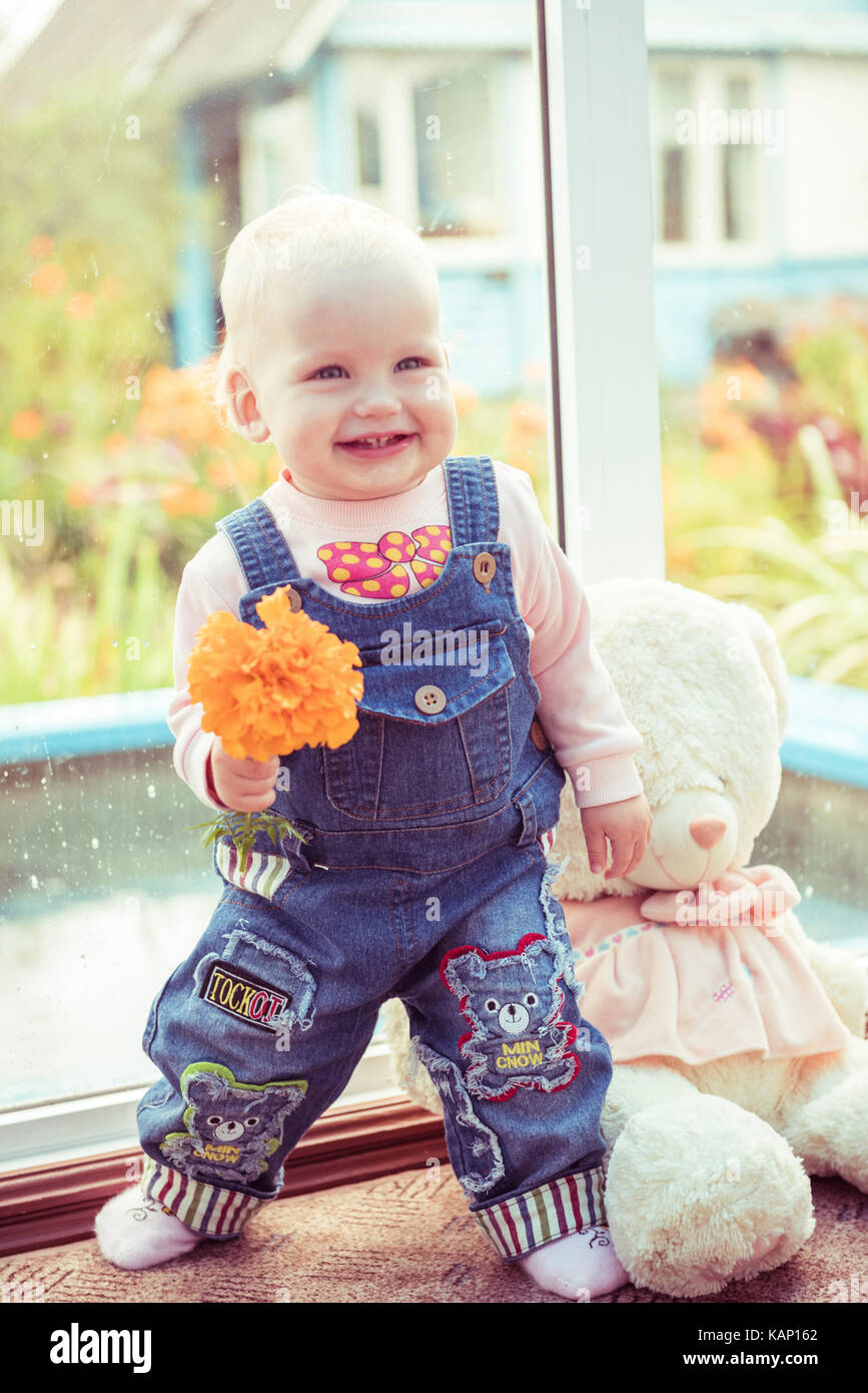 baby and teddy bear friends at home with flower Stock Photo