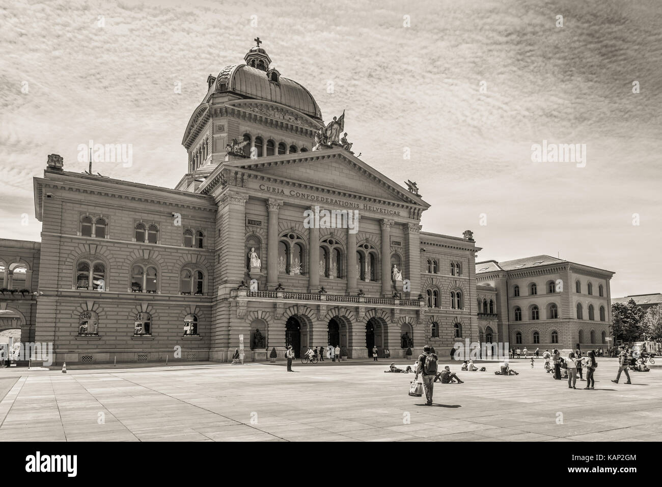 Bern, Switzerland - May 26, 2016: People are resting on the square in front of the Swiss Parliament Building (Bundesplatz) in Bern, Switzerland. Sepia Stock Photo
