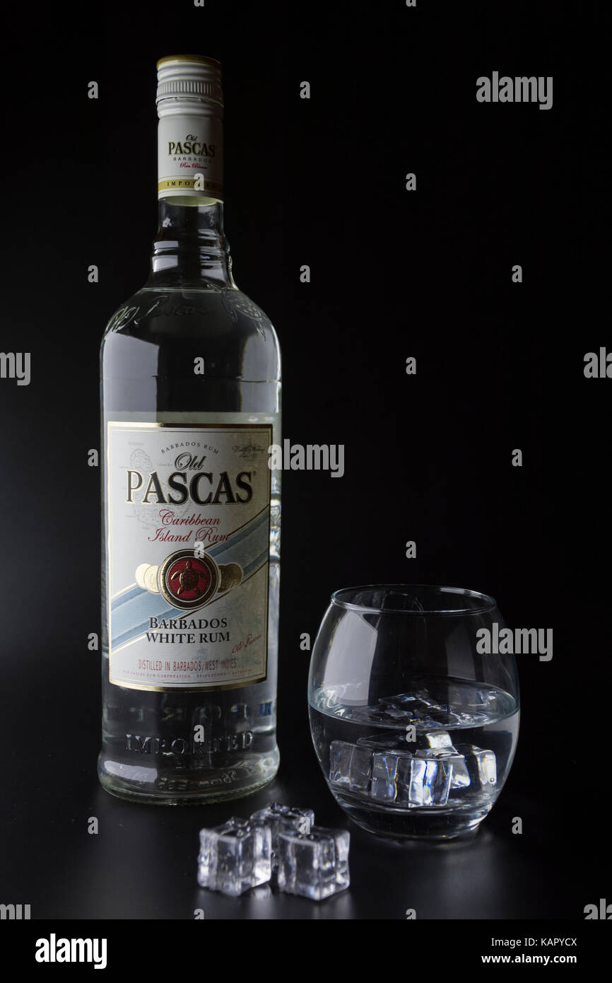 TIRASPOL, MOLDOVA - JUNE 5, 2016: Caribbean white rum bottles Old Pascas on a black background with a glass of ice. Rum Old Pascas perfect for cocktai Stock Photo