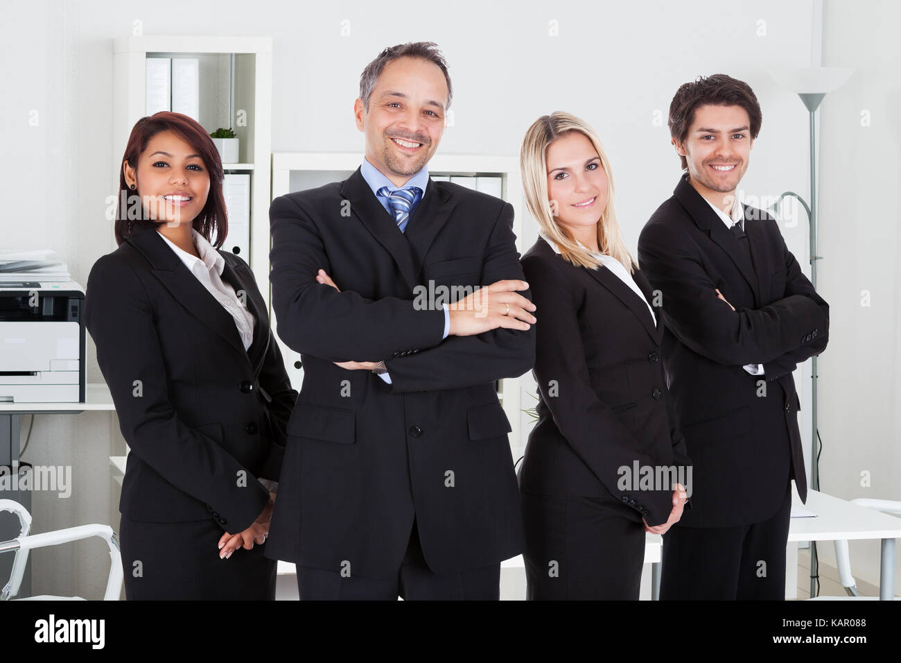 Portrait of confident business team standing together in office Stock ...