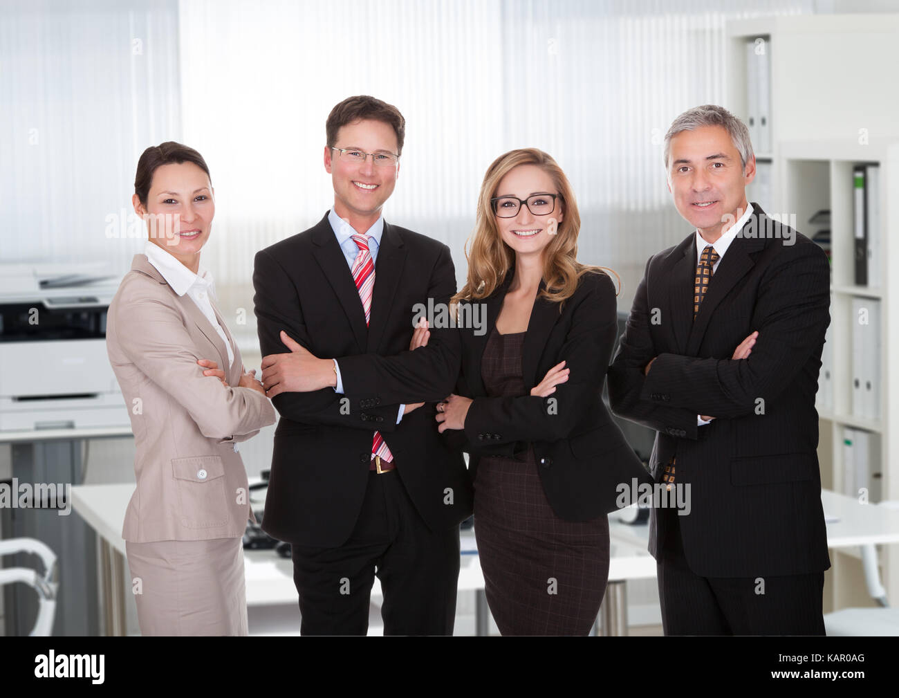 Portrait of confident business team standing together in office Stock ...
