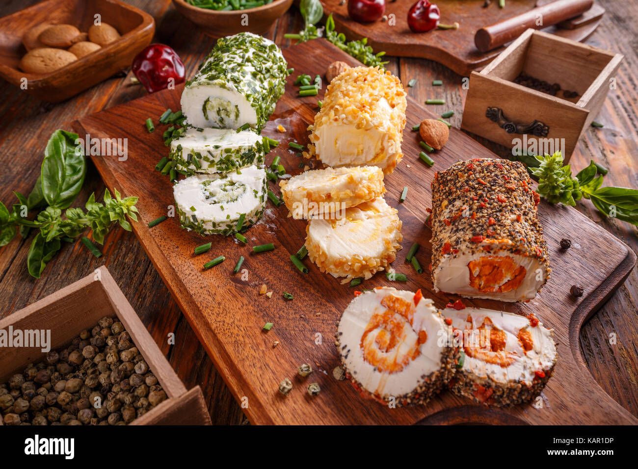 Cottage cheese with colorful stuffing on wooden cutting board Stock Photo