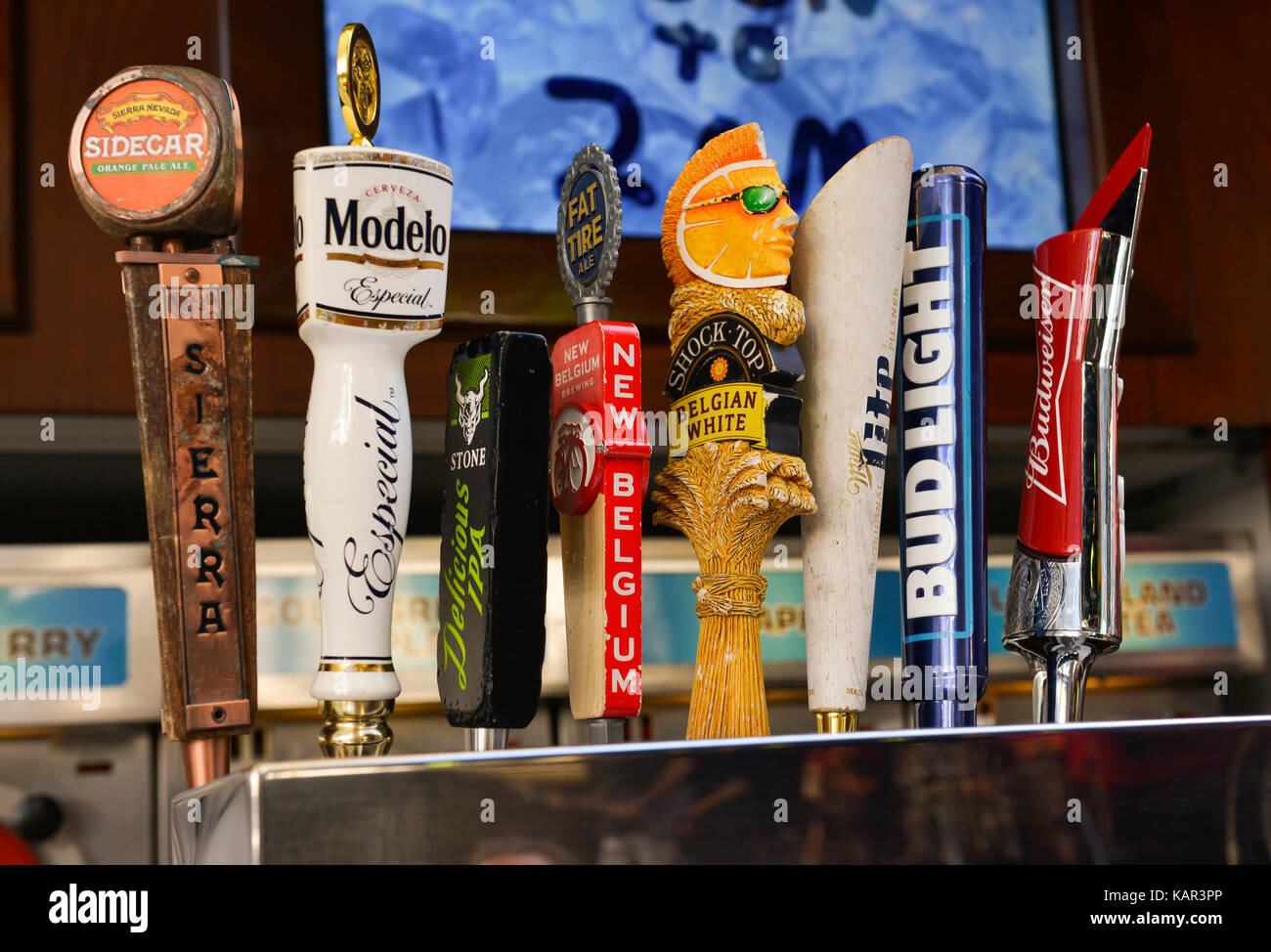 Assorted beer taps behind bar Stock Photo