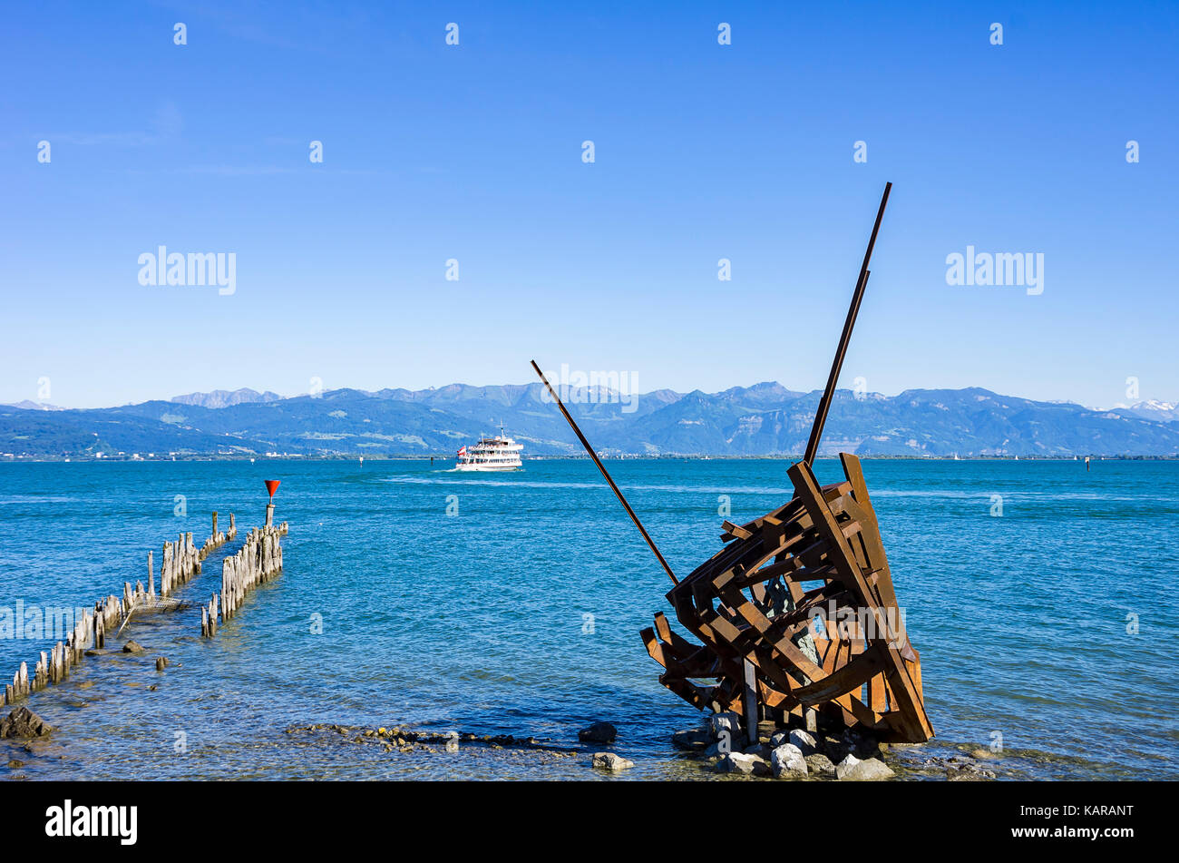 View across Lake Constance with shipwreck artwork Styx by Günther Stilling in the foreground, Wasserburg, Bavaria, Germany. Stock Photo