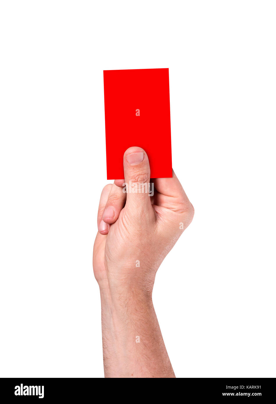A male sports referee or umpire hand holding a card up in the air on an isolated white studio background Stock Photo