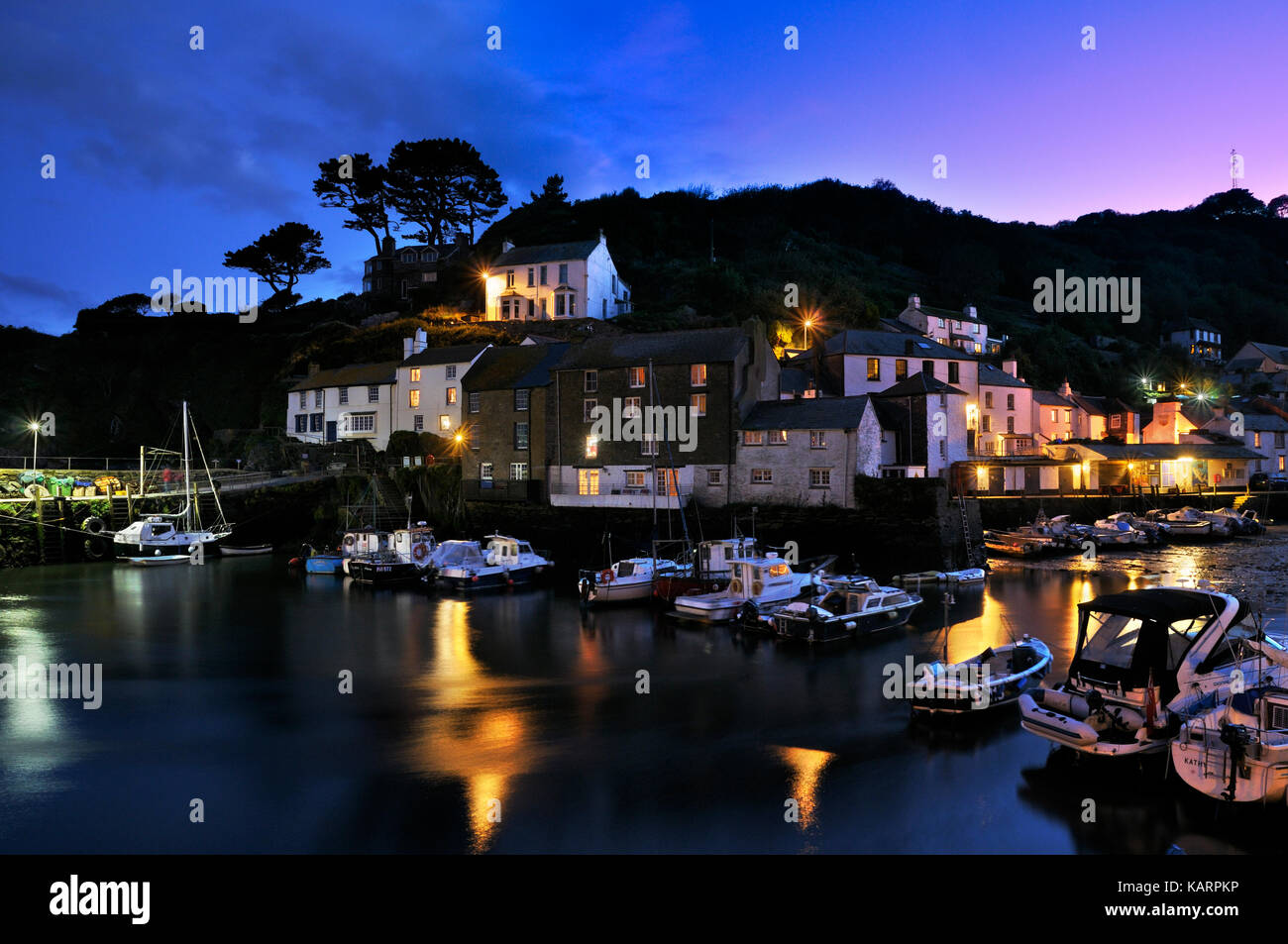 Polperro, Cornwall. Unfailingly busy on summer days, the sleepy Cornish fishing village returns to an atmospheric calm at twilight... Stock Photo