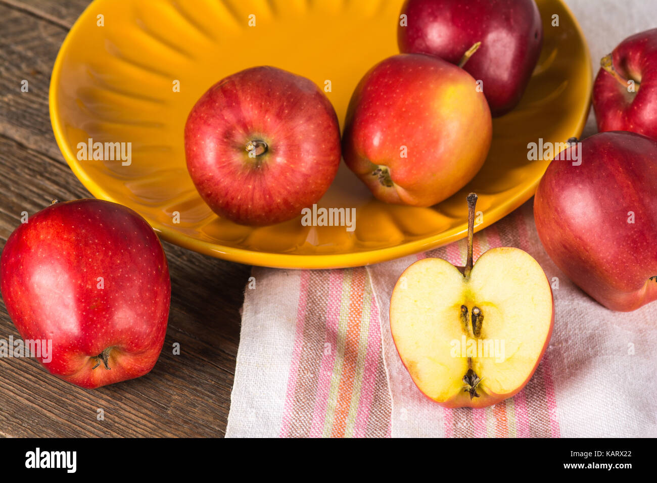 Ripe red apples on plate Stock Photo