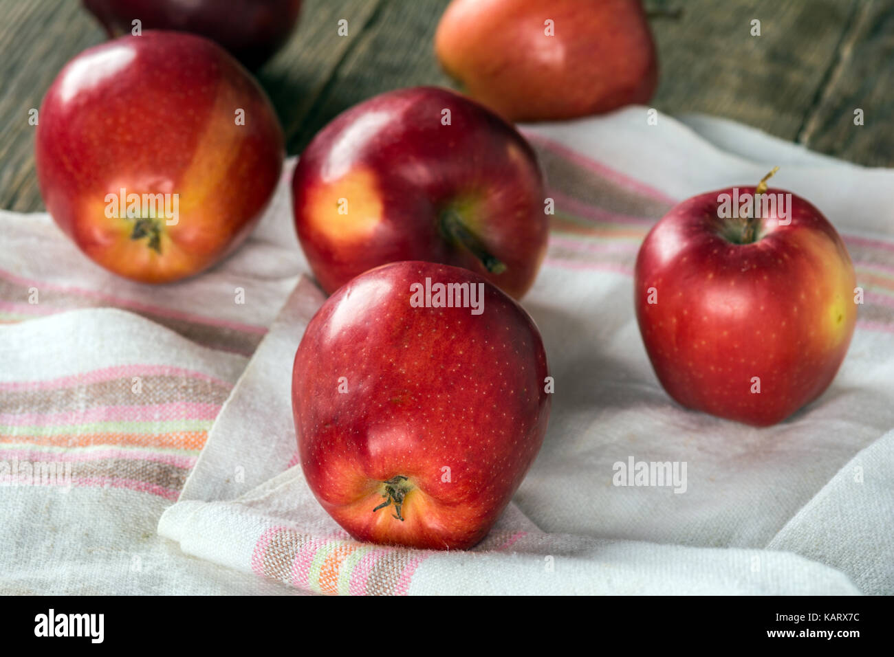 Ripe red apples on wooden surface Stock Photo