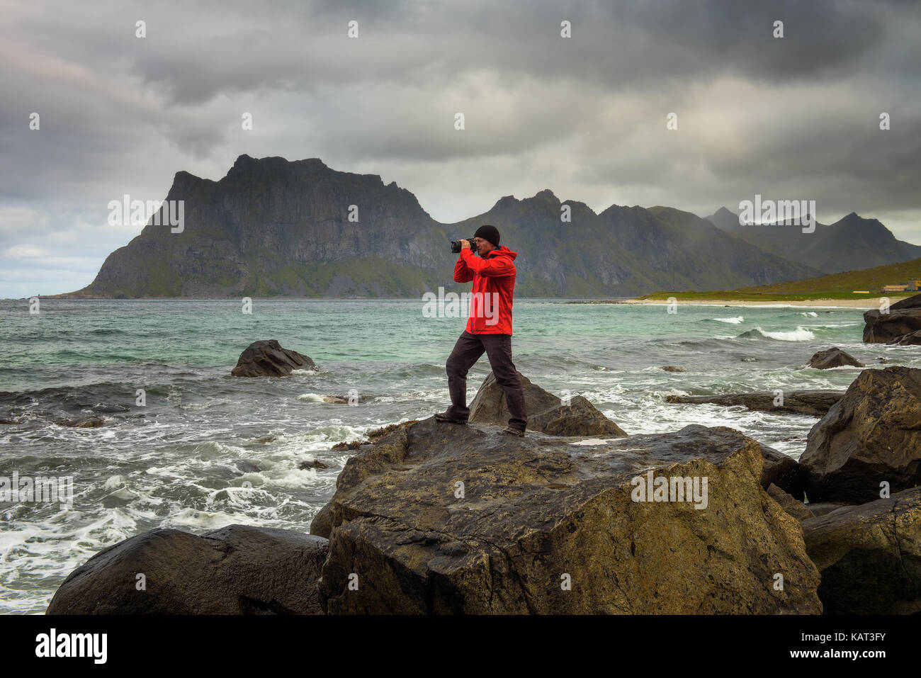 Photographer takes pictures at Uttakleiv beach on Lofoten islands in Norway Stock Photo