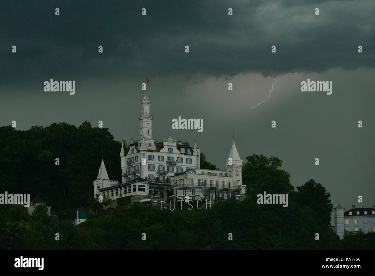 Lightning strike against a grey story sky, over the Gutsch hotel, Luzern, Switzerland Stock Photo